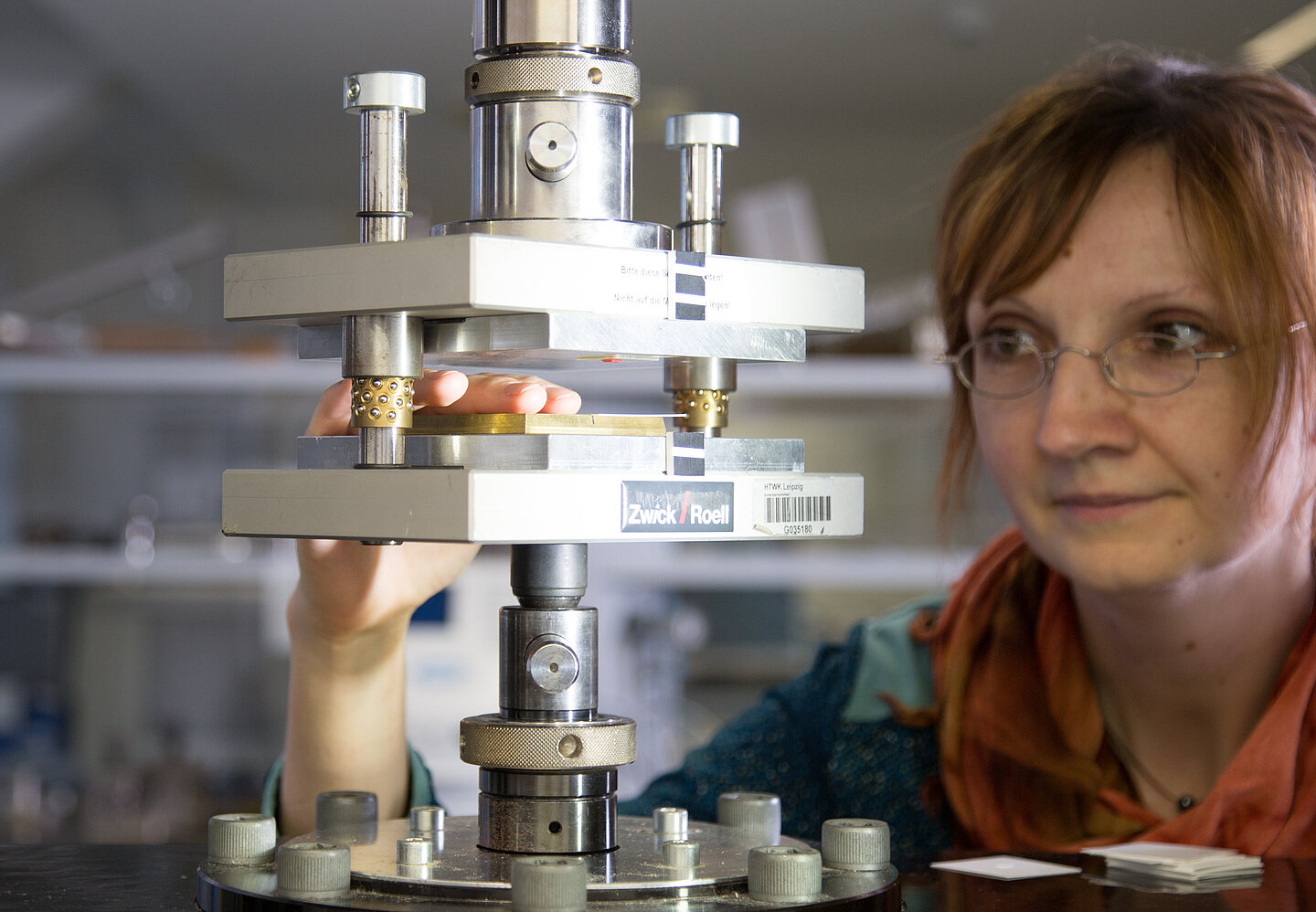 Prägemaschine Eine Frau arbeitet mit mit der Prägemaschine