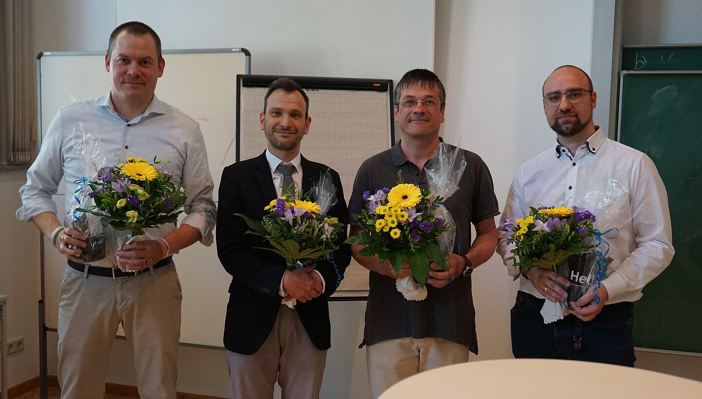 Die Nominierten 2024 (v.l.: Dr. Steffen Hundt, Dr. Volker Gruhne, Dr. Gregor Peltri, Prof. Paul Rosemann (Andreas Frieser war nicht anwesend; Foto: HTWK Leipzig) vier Personen mit Blumenstrauß