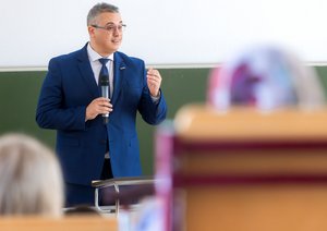 Grußwort ein Mann spricht ins Mikrofon